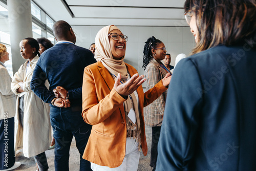 Smiling Muslim businesswoman sharing and talking during a networking event