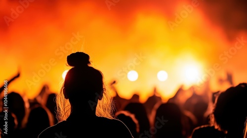 This dynamic image captures a person's silhouette in front of blazing concert stage lights, exuding energy, anticipation, and the thrill of live musical performance.