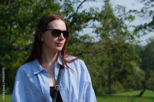 Portrait of a woman. Woman auburn hair, sunglasses.