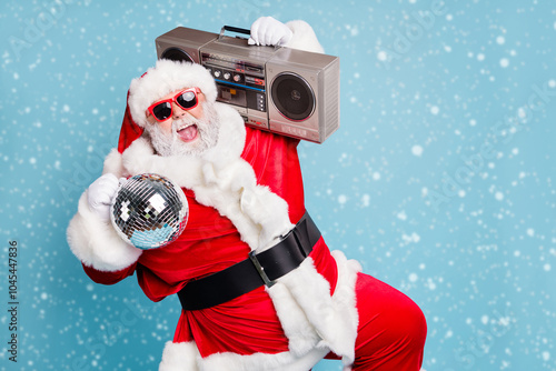 Portrait of his he nice cool fat cheerful cheery glad excited ecstatic overjoyed crazy carefree bearded Santa carrying tape player dancing having fun isolated on blue turquoise pastel color background