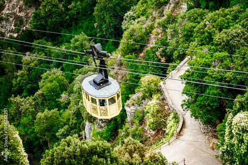 Montserrat Aerial Cableway, a yellow funicular that goes up with passengers to the Montserrat Mountain and the Monastery, Barcelona, ​​Catalonia