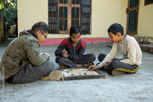 Indian village boys focus intently on a carrom board while playing together in a courtyard, surrounded by pastel-colored walls and a calming atmosphere.