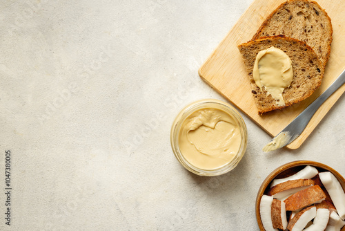 Jar of coconut butter cream and multigrain bread. Sugar and lactose free breakfast