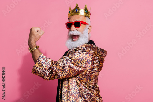 Photo of cool old man winning raise fist wear glamour leopard print outfit isolated pink color background