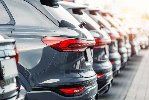 Back view many modern new SUV cars fleet stock at dealership parking lot. Automobile market production factory industry warehouse. Auto salvage buy and sell auction purchase seller platform