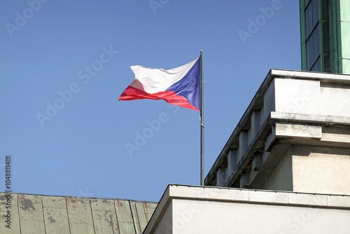 Czech national flag waving in wind on building with blue sky and copyspace