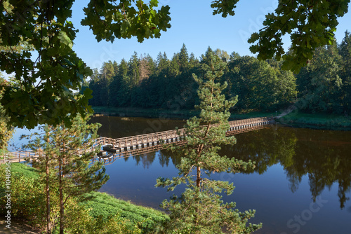 Pedestrian pontoon bridge over the Ogre River in the town of Ogre, Latvia.