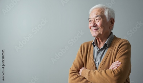 Senior man with cheerful expression contemplating life against neutral background with copy space