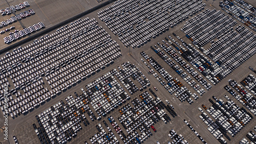 Top view of the electric vehicle transport yard and intercontinental shipping industry..