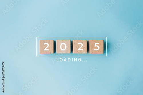 2025 New Year Loading. Loading bar with wooden blocks 2025 on blue background. Start new year 2025 with goal plan, goal concept, action plan, strategy, new year business vision.