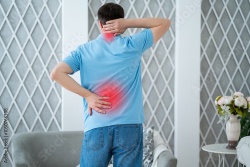 Back and neck pain, lumbar and cervical spine hernia, man with backache at home