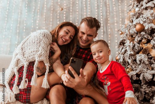 young family taking selfie at home and having fun, Christmas concept, holidays