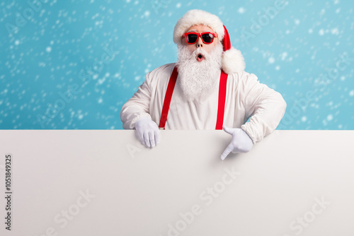 Portrait of his he nice attractive funky amazed wondered white-haired Santa demonstrating copy space board advert ad look idea solution isolated over bright vivid shine vibrant blue color background