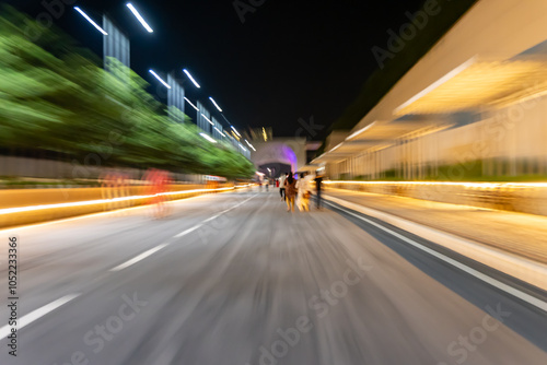 dreamy Blurred Motion Night Street Scene with City Lights with focus pulling effect