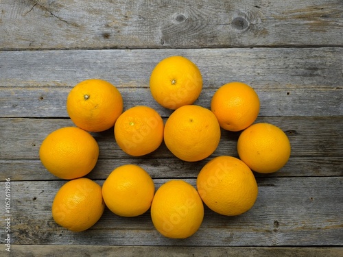 juicy oranges on a wooden table.