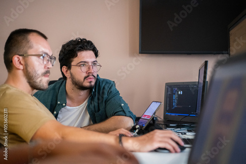 Programmers engrossed in deep collaboration, diligently working together to solve complex problems and develop innovative mobile applications with seamless functionality.