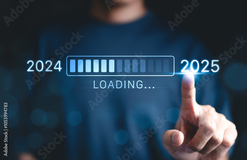 Progress and transition from 2024 to 2025 concept. A person pointing to loading bar transitioning from 2024 to 2025, progress, future planning, and new year goals. annual planning and business growth.