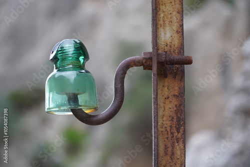 Old glass insulator from the beginning of the 20th century, when hydroelectric power stations were built in the Gaitanes Gorge in southern Spain. El Chorro, Malaga province, Spain, Europe.