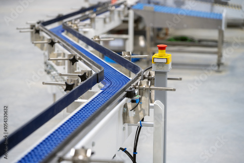 Plastic zet shaped chain conveyor and emergency button in food manufacturing plant