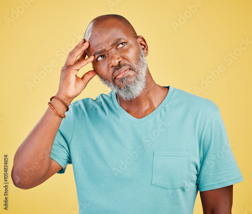 Thinking, confused and mature black man in studio with memory, problem solving or decision. Remember, doubt and frustrated person with brainstorming, ideas and planning choice on yellow background