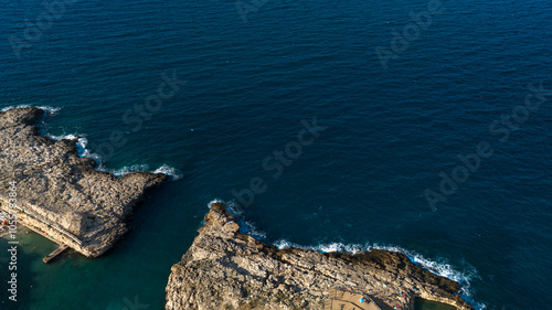 Aerial view of the mouth of a river flowing into the sea.