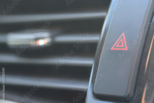 The image showcases the car's hazard warning light button, easily recognizable with its red triangle symbol on a black background.