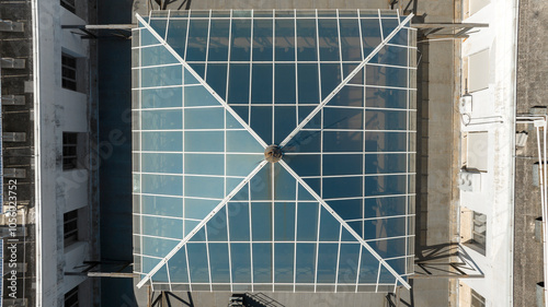 Perpendicular aerial view of a square glass window of a building.