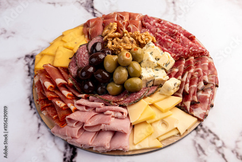 cold cuts table with assorted cheeses, Sardinian provolone and flavoured with oregano and olives, homemade bread with loin, ham, pork shoulder, bacon, salami, mortadella with nuts and a variety of col