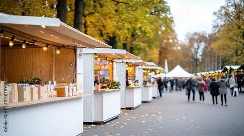 A panoramic view of a festive outdoor event such as a holiday market or festival showcasing numerous stalls and booths, all adorned with colorful lights. Attendees are visible enjoying the festive