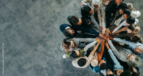 Diverse business team uniting with hands together in a show of teamwork and collaboration