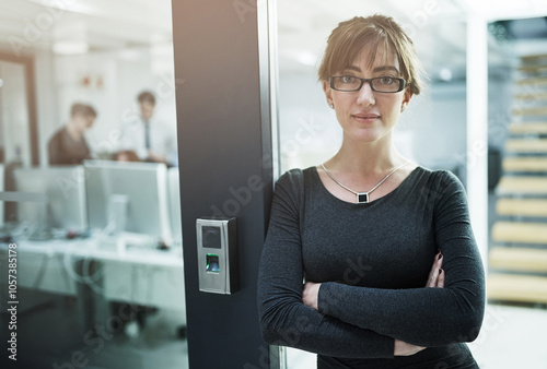 Arms crossed, doorway and portrait of business woman in office for job opportunity or start of internship. Confident, glasses and serious with assertive employee at entrance to workplace for ambition