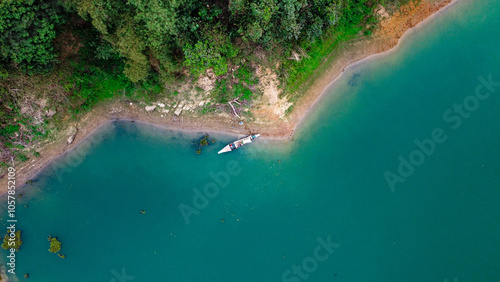 Aerial View of a tropical boatman in turquoise blue water of Rangamati lake, Bangladesh.