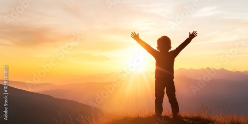 A joyful child celebrating at sunset, arms wide open against a beautiful mountain landscape with a warm golden glow.