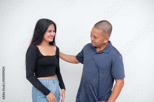 A young asian woman giving reassuring and encouraging pep talk from her supportive dad or uncle. Isolated on a white background.