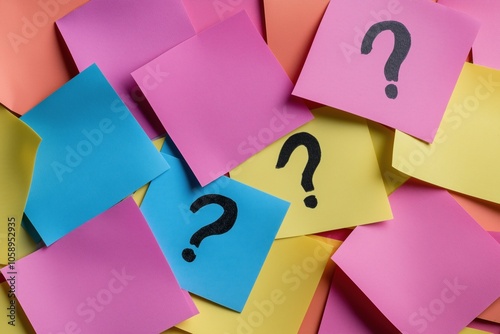 A bunch of colorful sticky notes with a black question mark on them. The notes are scattered all over the image, creating a sense of confusion and disorganization