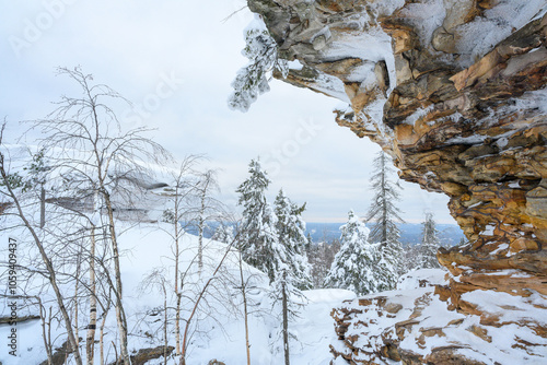 Stone city in the woods moss-grown nature in the winter. Usva, Ural.