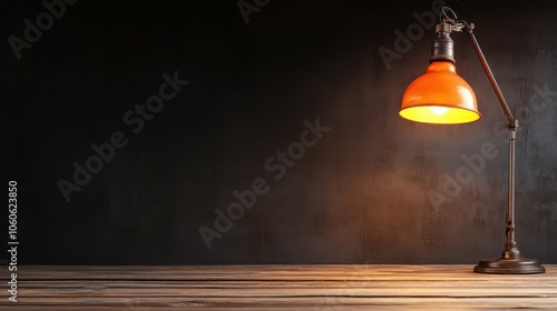 An antique desk lamp with an orange shade casts warm light over a rustic wooden table, creating a peaceful, nostalgic atmosphere in the dim room.