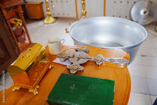 a baptismal font and a table with attributes for the sacrament of baptism in the church. Christian traditions.