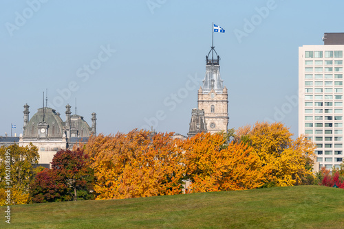 The tower of the Quebec parliament with in foreground the battlefields park of the plains of Abraham and colorful autumn trees (Québec city, Québec, Canada)