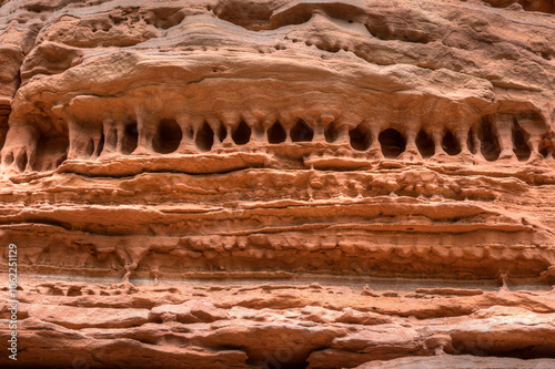 A bizarre sandstone rock formation reminiscent of ancient cliff dwellings. The striking structure features natural ledges and caves shaped by the forces of wind and weather.