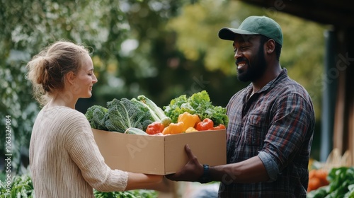 Black male farmer giving box full of fresh vegetables to caucasian woman at farmers market