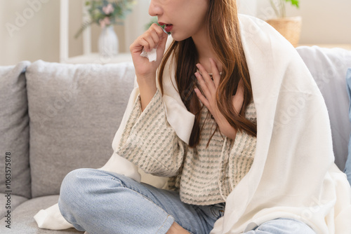 Unforeseen Discomfort: A Woman Experiences a Sudden Cough, Close-up of a woman coughing and feel chest pain.