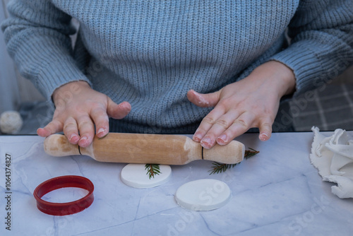 Creator is using white air dry clay for making decor to Christmas tree holiday. Creating hobby recreation activity that involves fingers. DIY crafting Modern art 