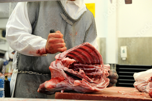 Meat carcasses being cut and disected in abattoir