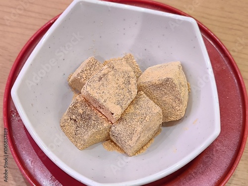 Warabimochi in white bowl. Japanese traditional dessert