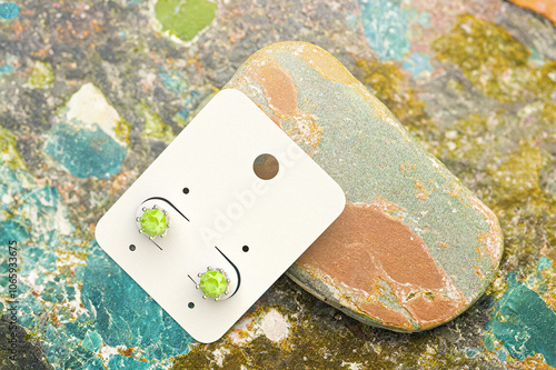 sample white earring cartouche in a setting of colored stones