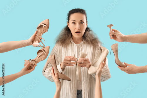 Shocked female shoemaker and hands with broken shoes on blue background