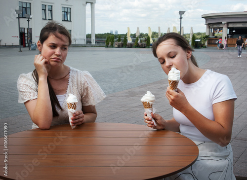 A woman looks at her friend with disapproval