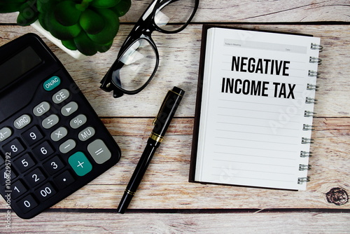 Negative Income Tax (NIT) text on notepad, Business and Financial concept background