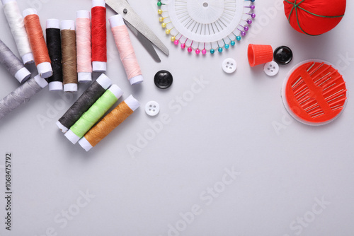 Tailor sewing accessories on gray background. Copy space